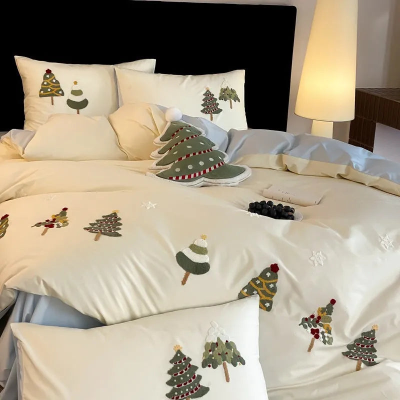 Cream blue embroidered Christmas tree and flowers on a cotton duvet cover with matching pillowcases
