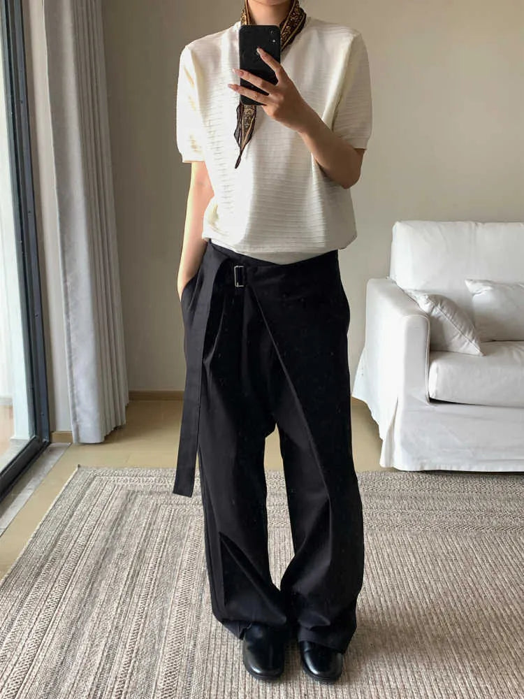 Black straight-leg trousers made from Tencel and cotton blend with a single pleat and adjustable waistband.