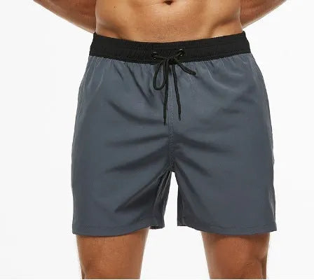 Men's blue training shorts with stitching waist detail and headband pocket