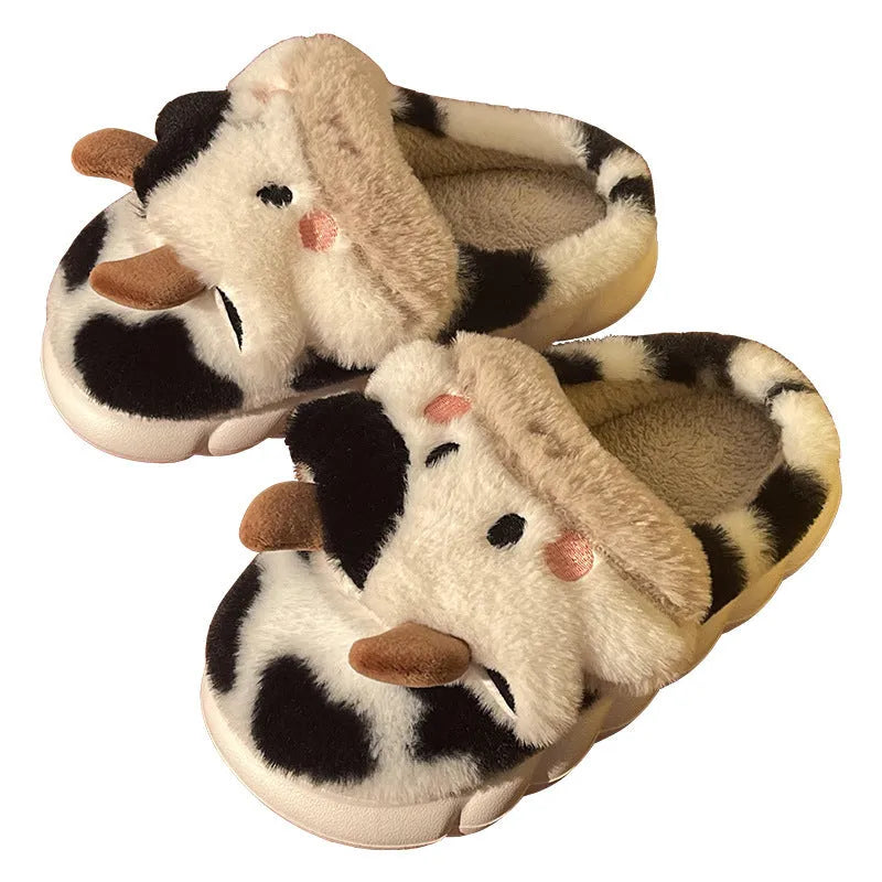 White and coffee coloured cow animal slippers for women with a plush exterior and non-slip sole.