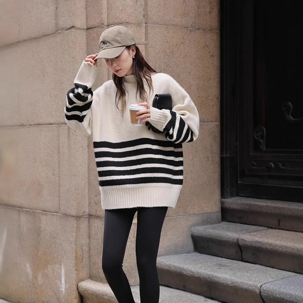 Beige loose maternity sweater with stand collar and long sleeves on a plain background
