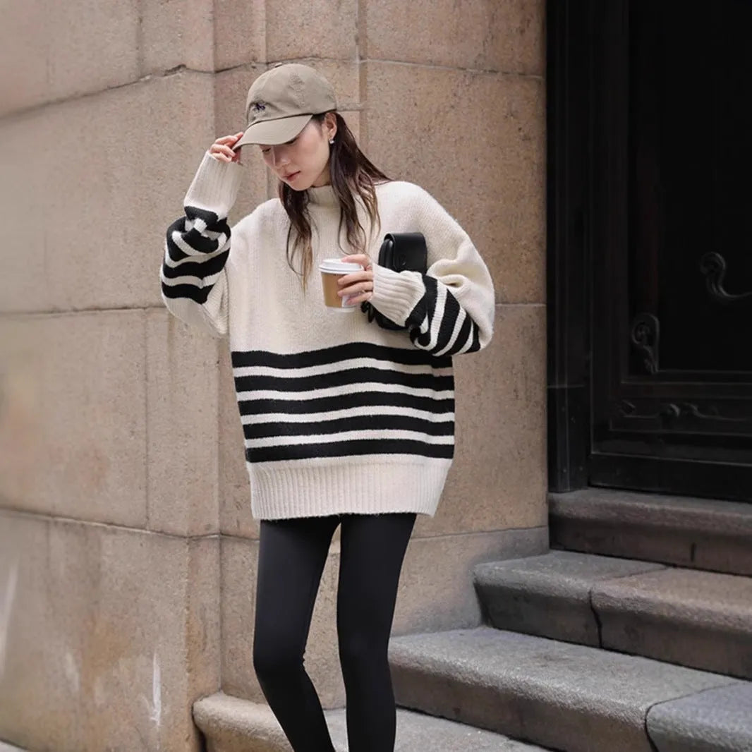 Beige loose maternity sweater with stand collar and long sleeves on a plain background