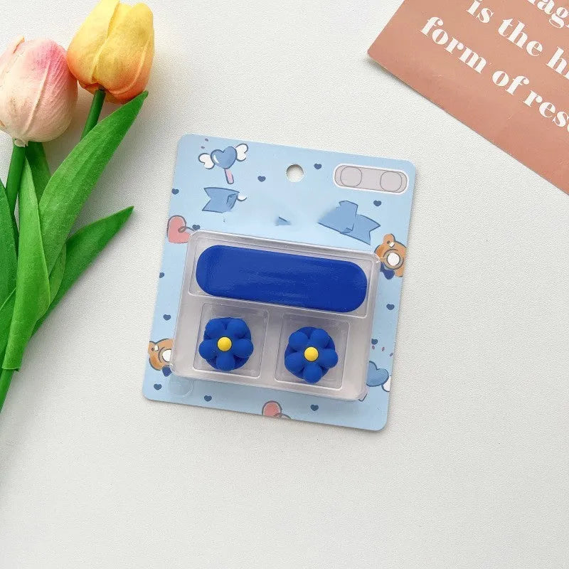 Cartoon magnetic protection data cable fixer in assorted colours on a desktop.