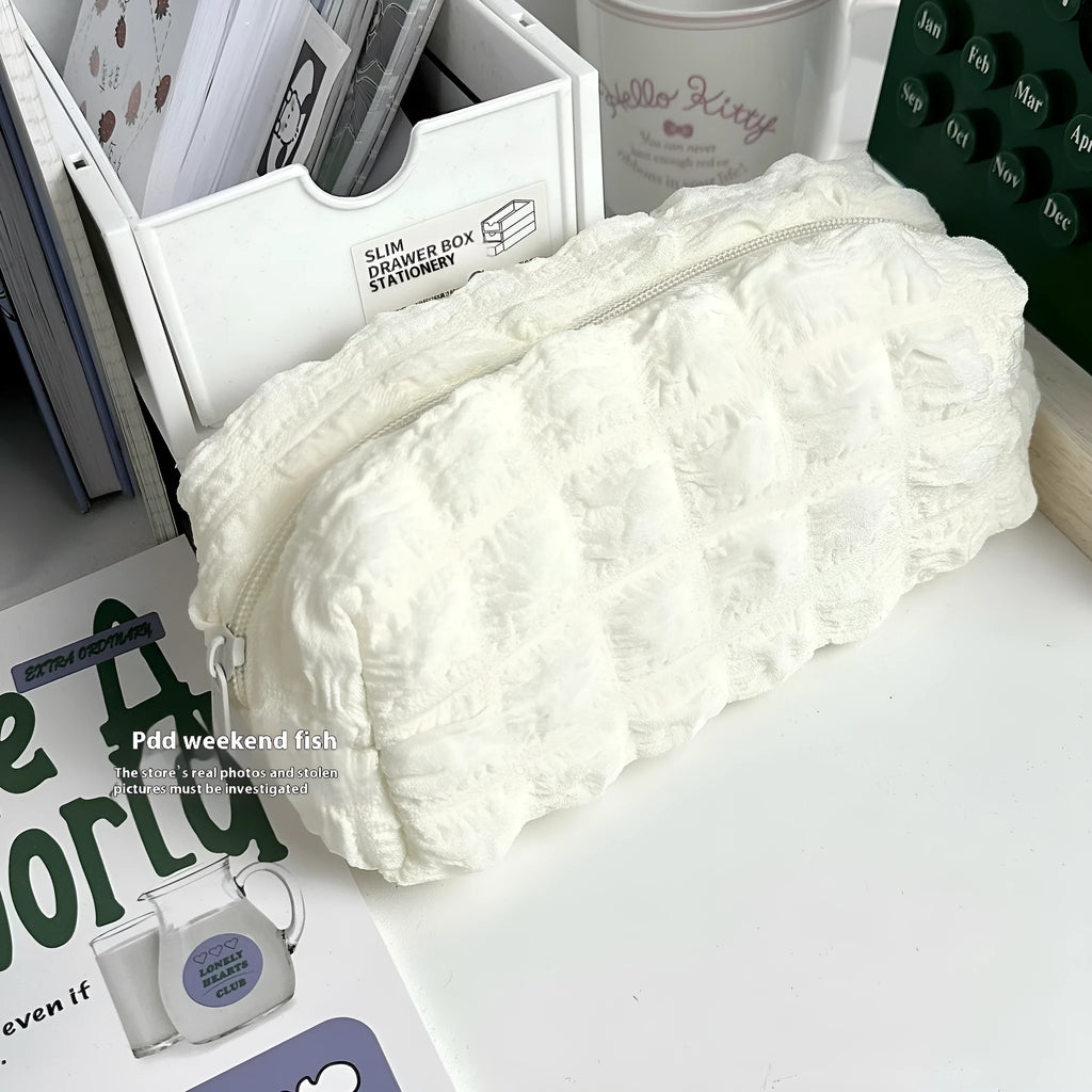 Cream puff style polyester fabric pencil case in beige colour with zip closure