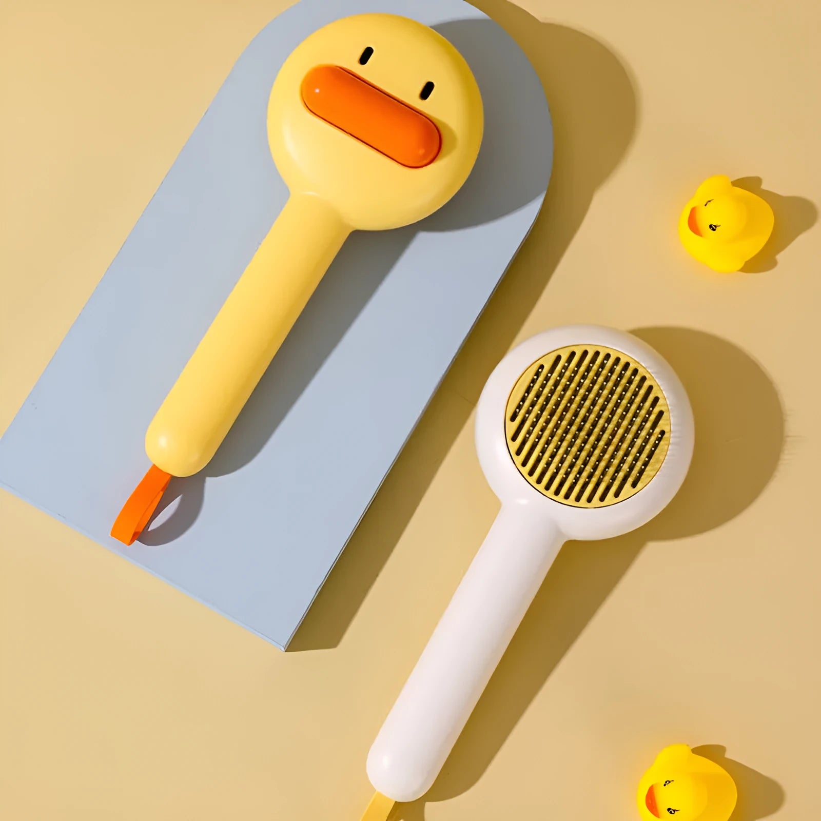Small yellow cat comb brush with open-section design and fine needles for pet grooming