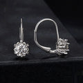 Close-up of a sterling silver flower bud ear clip with a white gold plated finish and a central 0.5 carat moissanite stone.