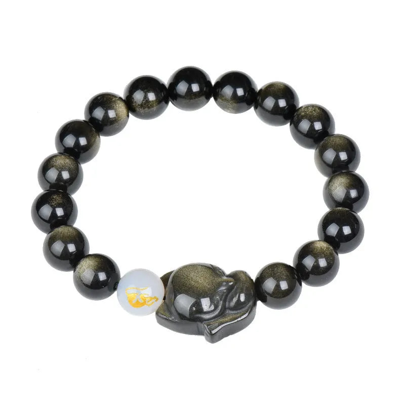 Natural black obsidian bracelet with 10mm beads on wrist, showing gold tone fastening option.