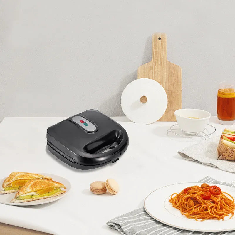 Black electric sandwich pan with brushed stainless steel top cover and exchangeable non-stick baking pans