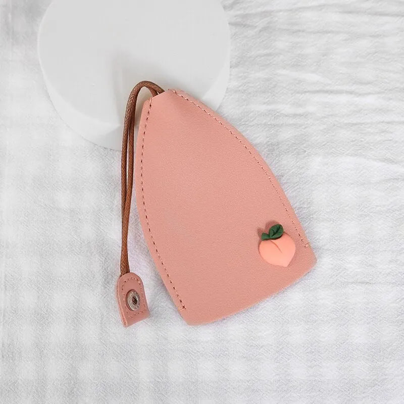 Colourful cartoon pull-out key protector case made from PU leather, showing a selection of fruit and animal designs.
