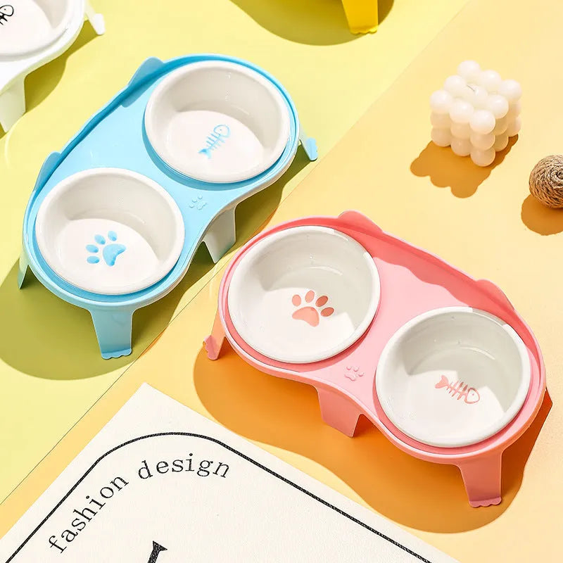 Blue ceramic pet bowl set elevated on a stand with a storage hook, showing food and water bowls.