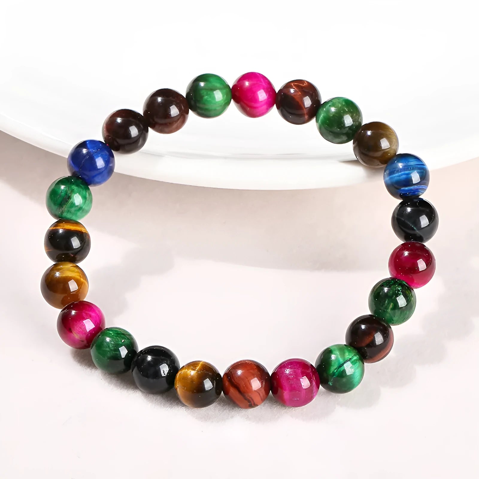 Colourful tiger eye bracelet with round beads in mixed sizes on a woman's wrist