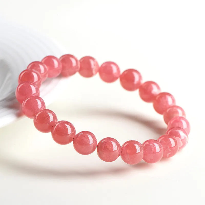 Women's geometric crystal bracelet with rhodochrosite stone and longevity lock in natural red patterns