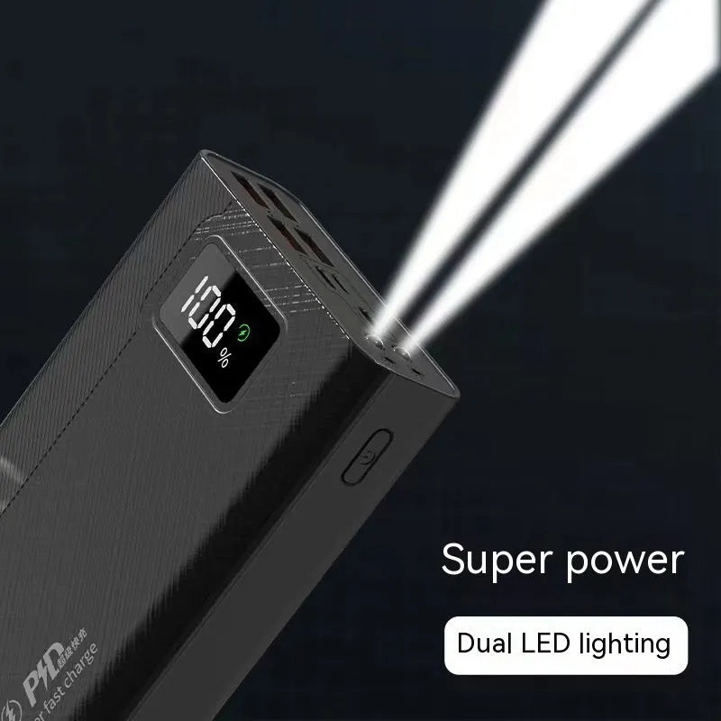 Black and white large capacity power bank with fast charging support, showing size scale.