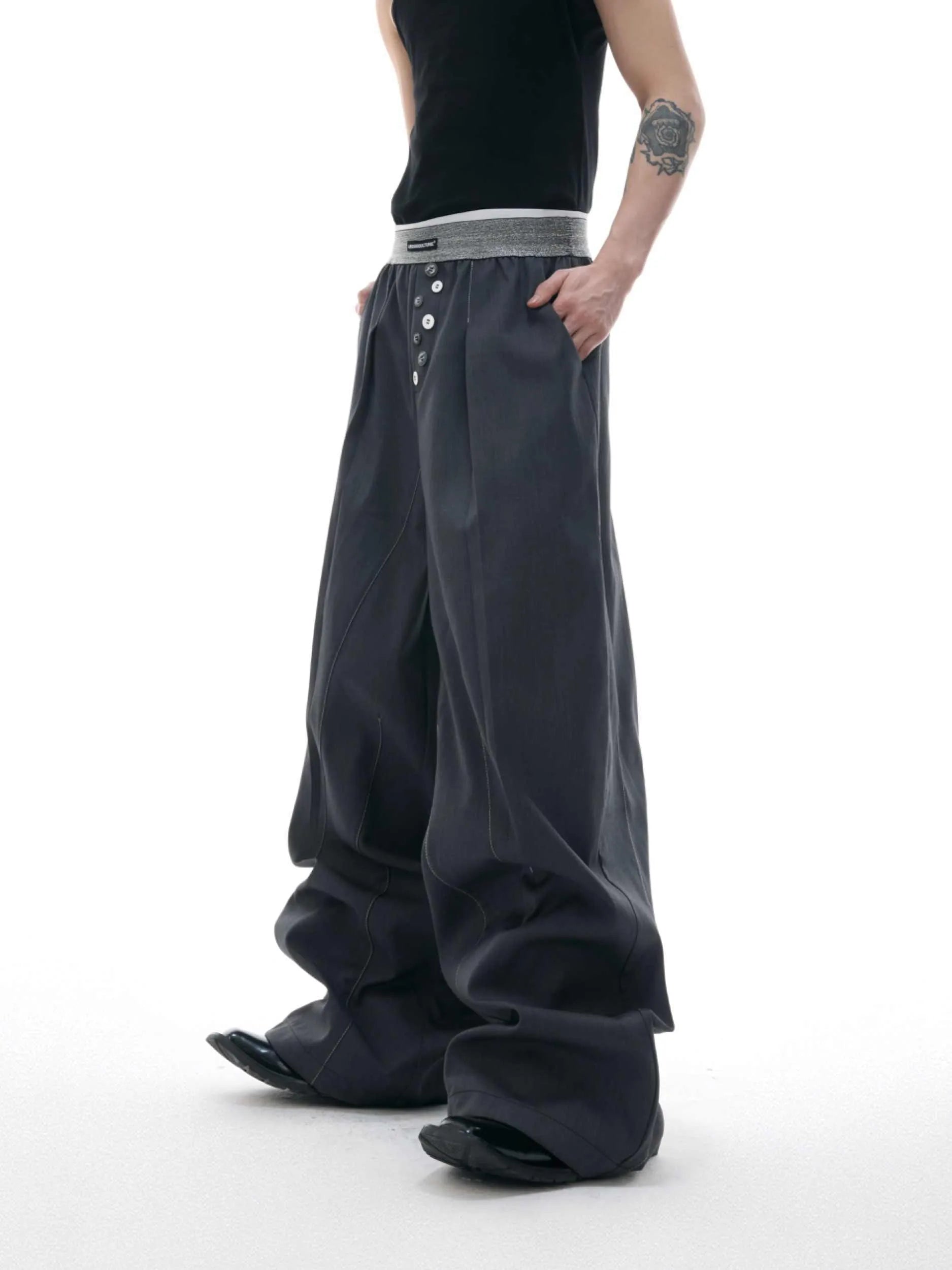 Men's straight-leg casual trousers with drooping design and button detail in black or grey