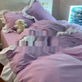 Washed cotton Mori style four-piece bedding set in solid colour on a bed, showing quilt cover, sheet, and pillowcases.