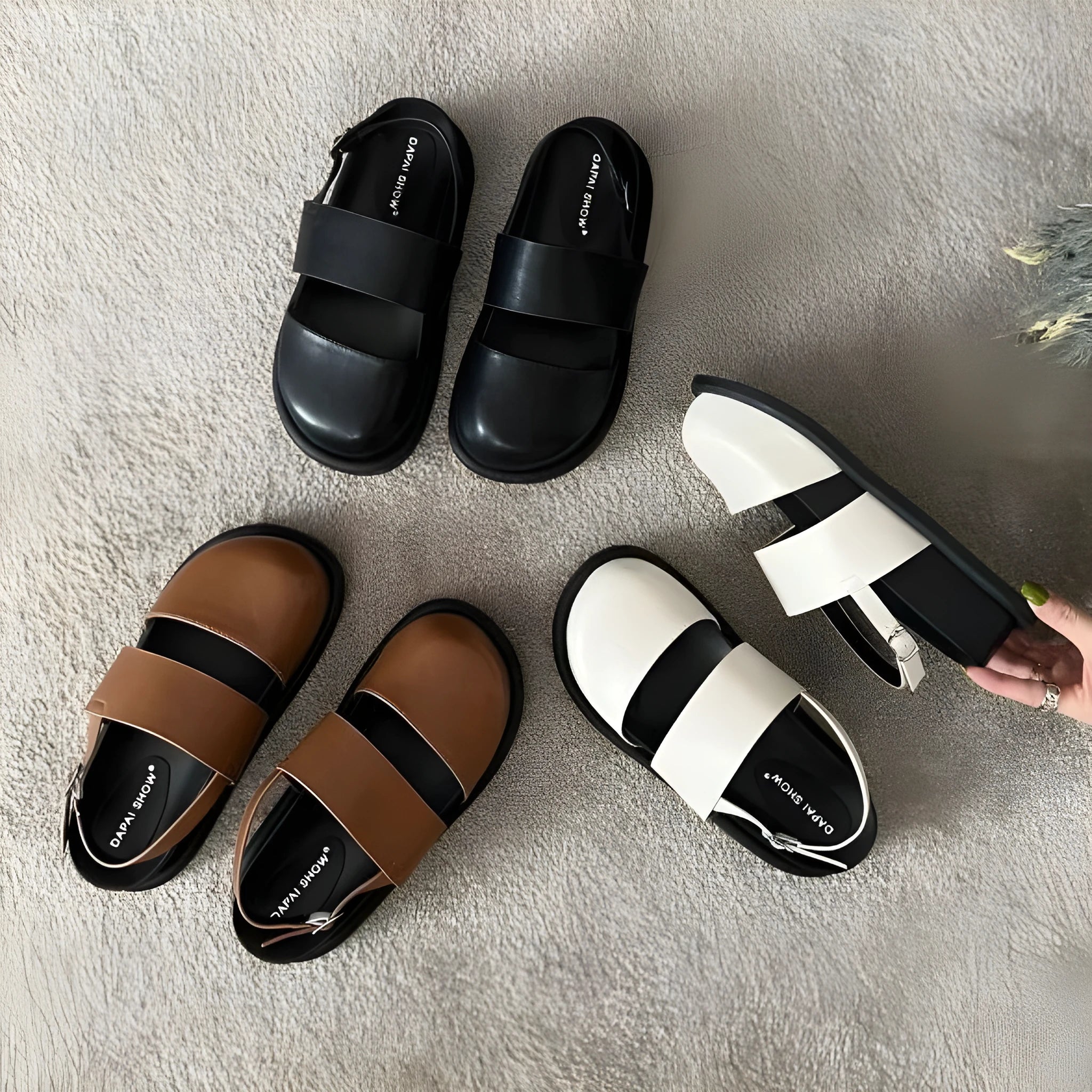 Retro closed toe sandals with an ankle buckle in apricot colour on a white background