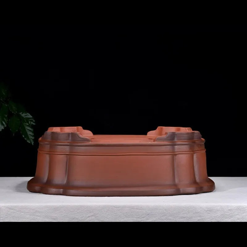 Large antique-style purple clay Chinese flower pot showing wide, shallow shape.