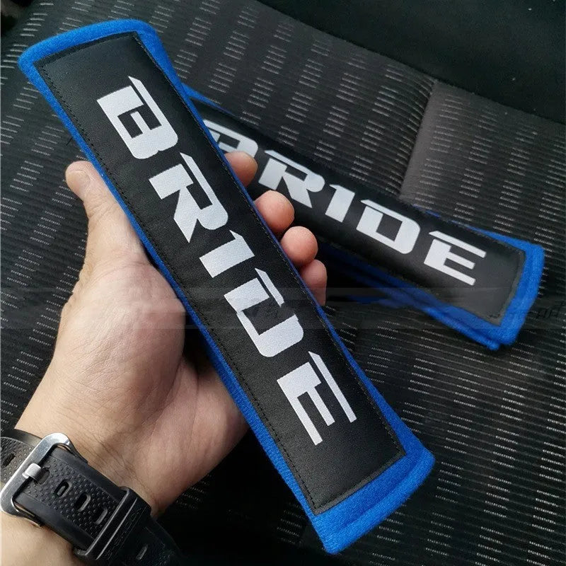 Car seat belt shoulder pads in black, blue and red with cotton fabric and sponge padding