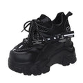 Women's white breathable mesh platform sports shoe with a cross strap on a rubber sole