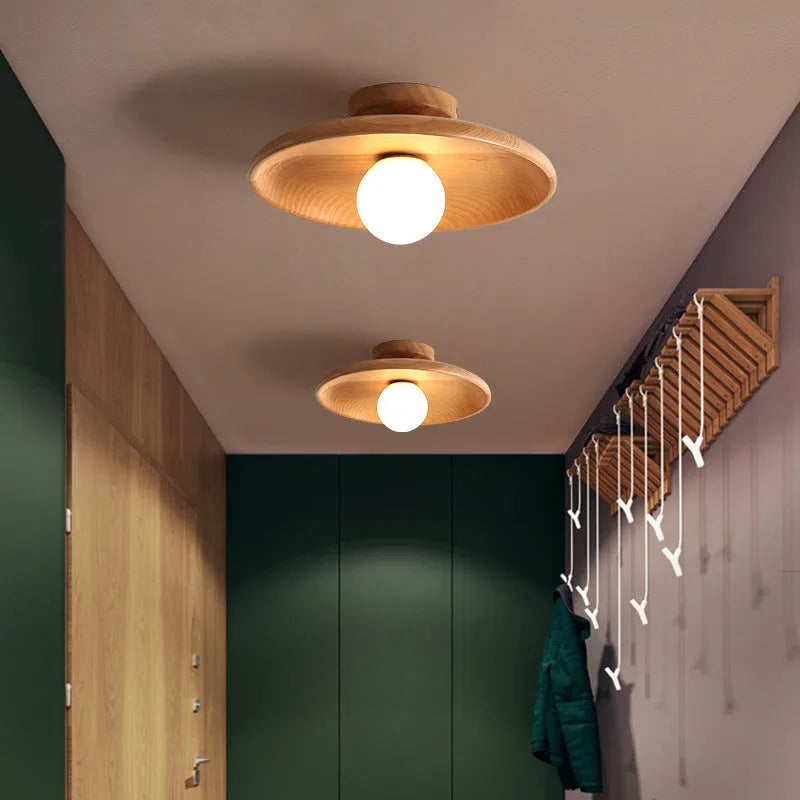 Solid wood ring ceiling lamp with glass shade in modern minimalist design.