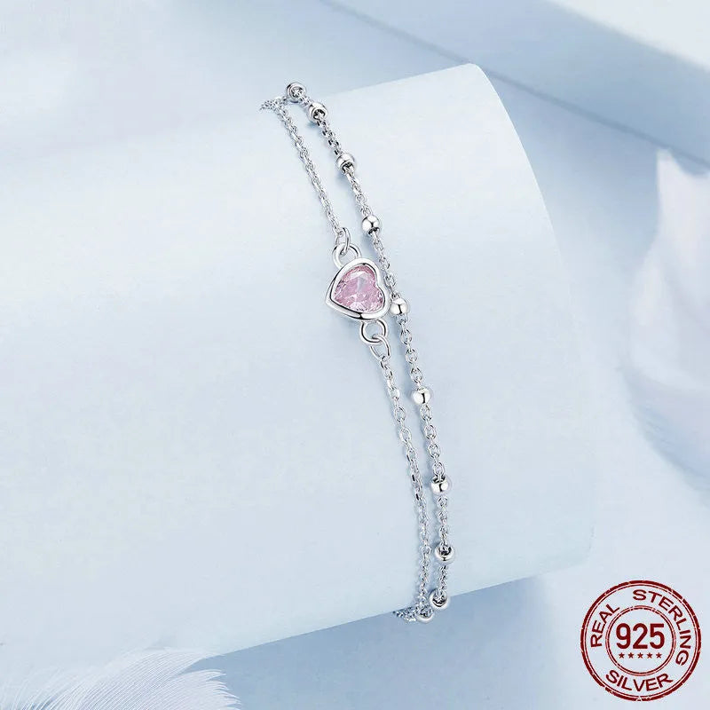 Women's sweet girlish style sterling silver bracelet with a small heart charm on an adjustable chain.