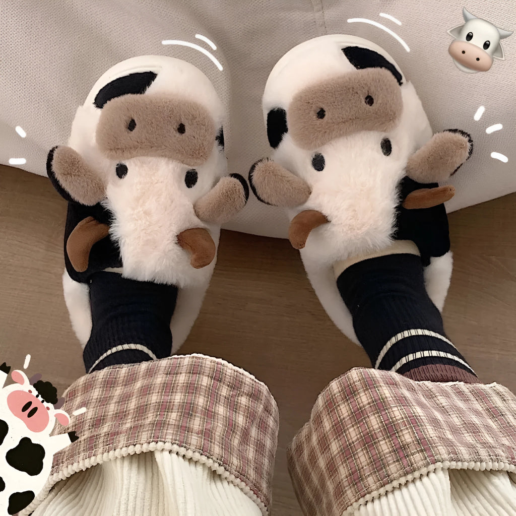 White and coffee coloured cow animal slippers for women with a plush exterior and non-slip sole.