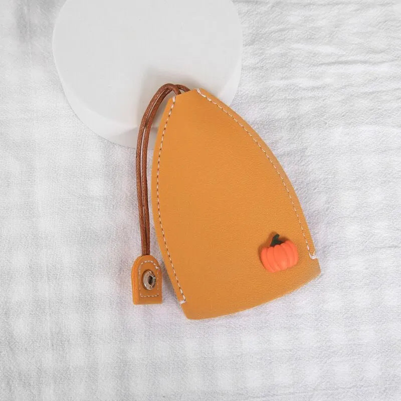 Colourful cartoon pull-out key protector case made from PU leather, showing a selection of fruit and animal designs.