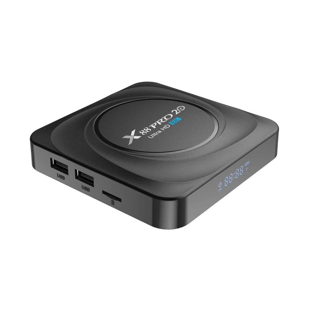 Compact black Android TV set-top box with remote control and HDMI cable on a wooden surface.
