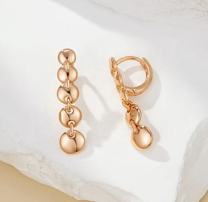 Long gold retro hoop earrings with woven copper texture, shown as a pair.