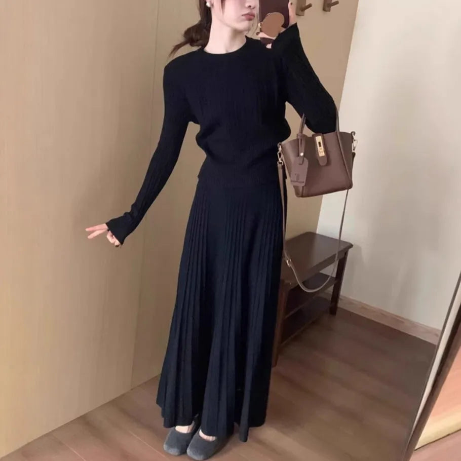 Women's dark grey knitted dress suit with 3D patterning and ethnic collage stitching, showing sweater and skirt two-piece set