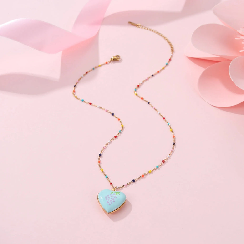 Stainless steel necklace with gold plated heart pendant featuring fruit design on adjustable chain