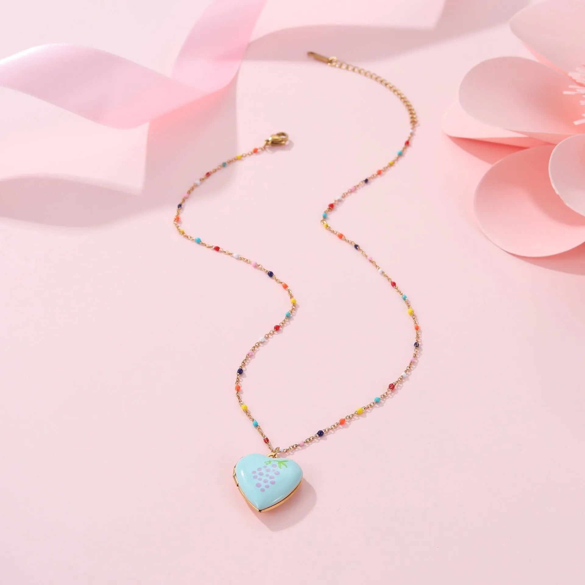 Stainless steel necklace with gold plated heart pendant featuring fruit design on adjustable chain