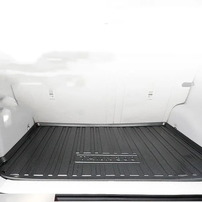 Black TPE car trunk pad with carbon fibre pattern installed in vehicle tailbox