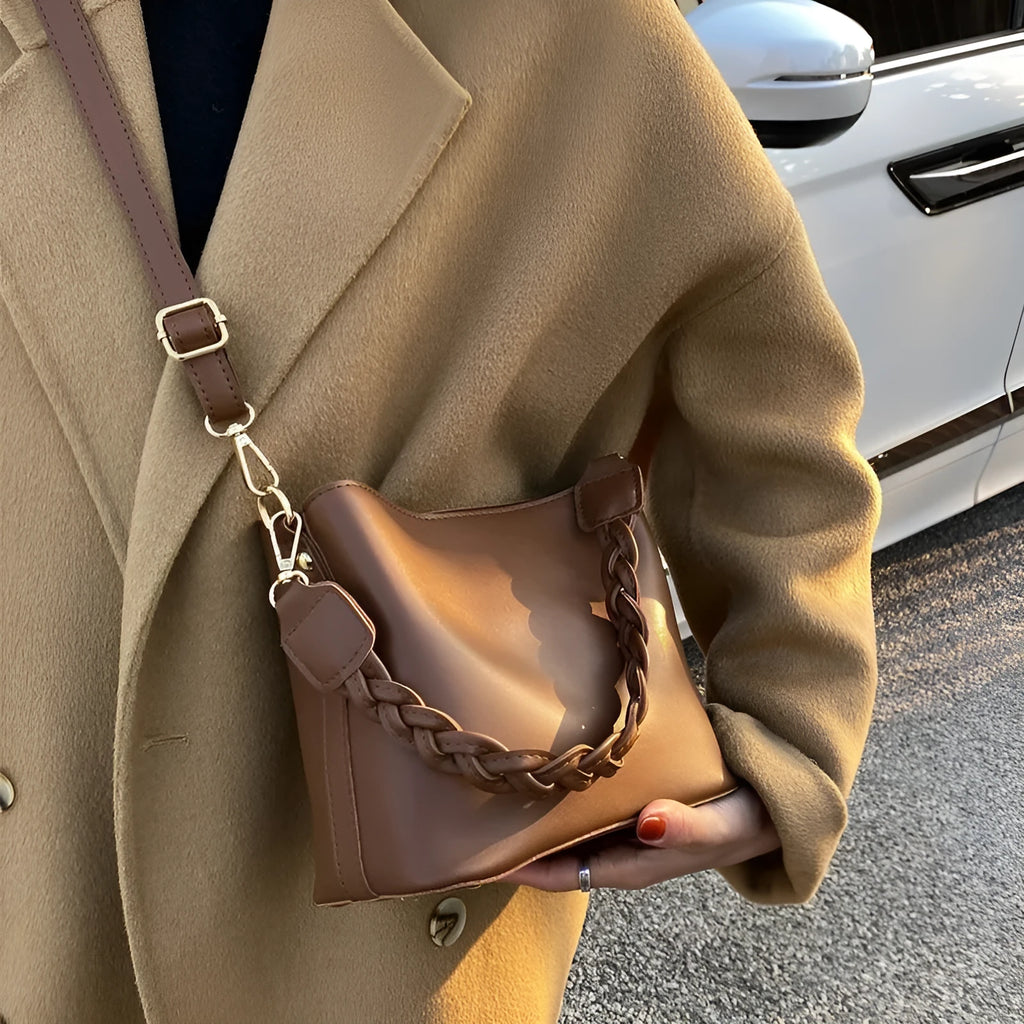 Retro woven PU bucket bag in khaki colour with crossbody strap shown in model shot
