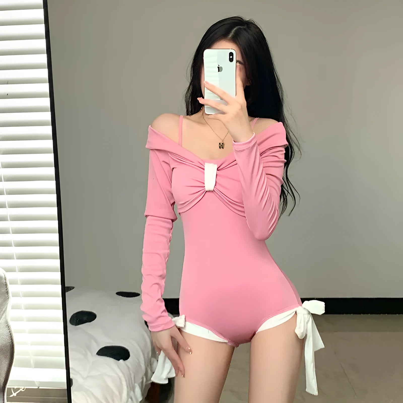 Women's long-sleeve one-piece swimsuit in black or pink colour with polyester construction