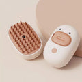 White and yellow electric pet steam brush with rubber comb teeth and ergonomic handle