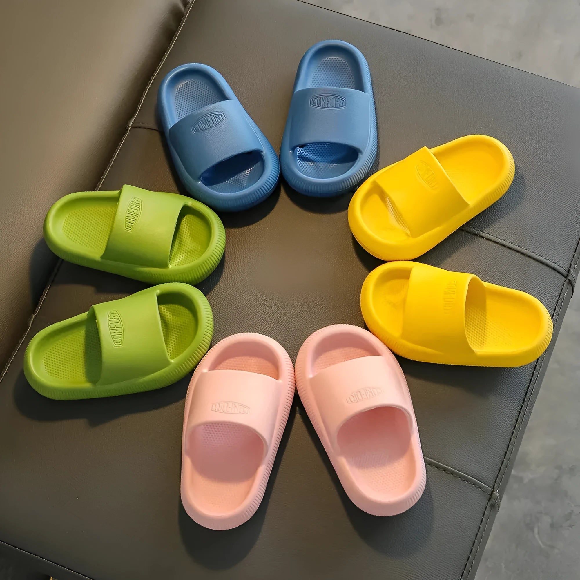 Children's EVA slippers in mixed colours with non-slip soles showing size range 24-35