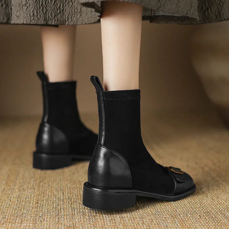 Women's black low-heel Martin boots with lace-up front and decorative belt buckle stitching.