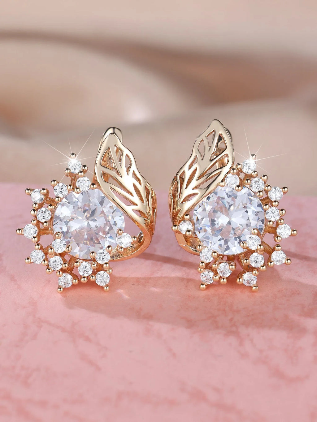 Rose gold coloured feather and flower design earrings with a choice of coloured zircon centre stones.
