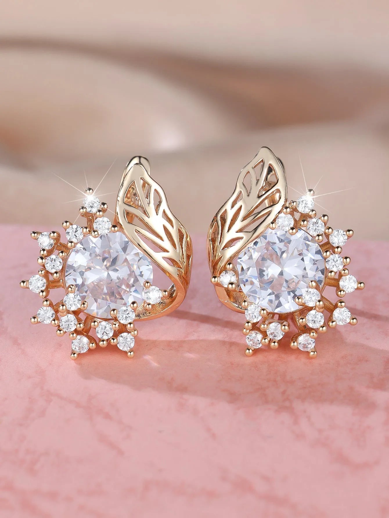 Rose gold coloured feather and flower design earrings with a choice of coloured zircon centre stones.