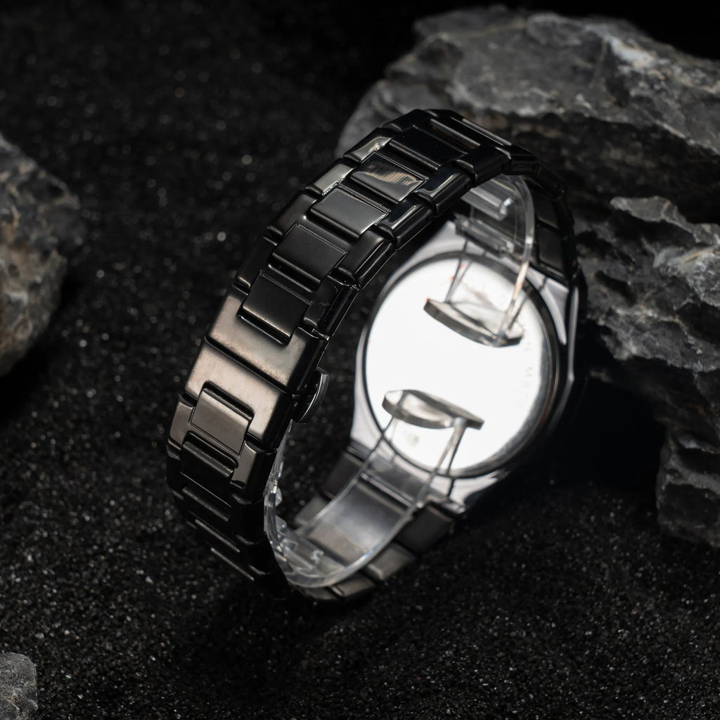 Men's business quartz watch with a steel bracelet and a black and silver dial on a wrist.