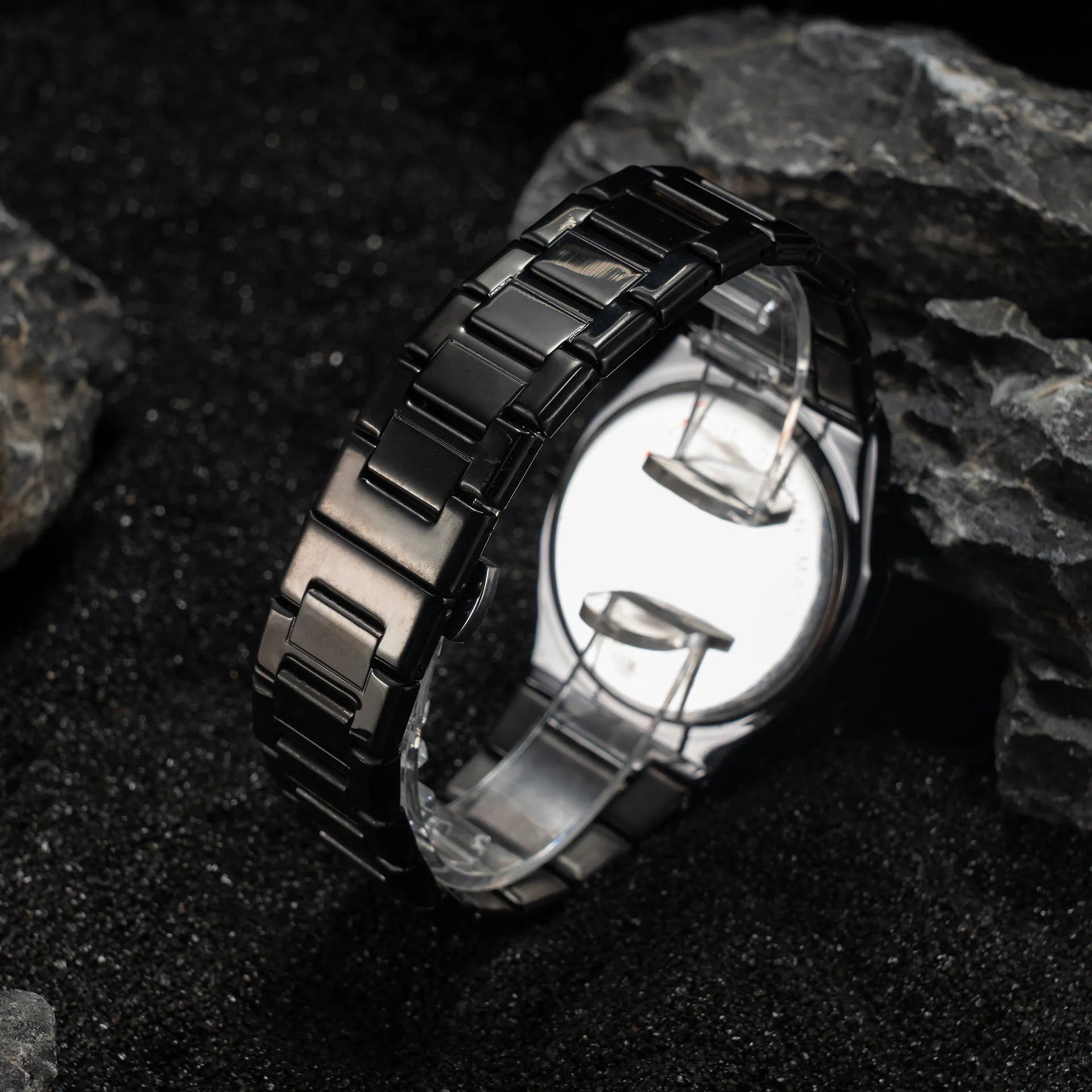 Men's business quartz watch with a steel bracelet and a black and silver dial on a wrist.