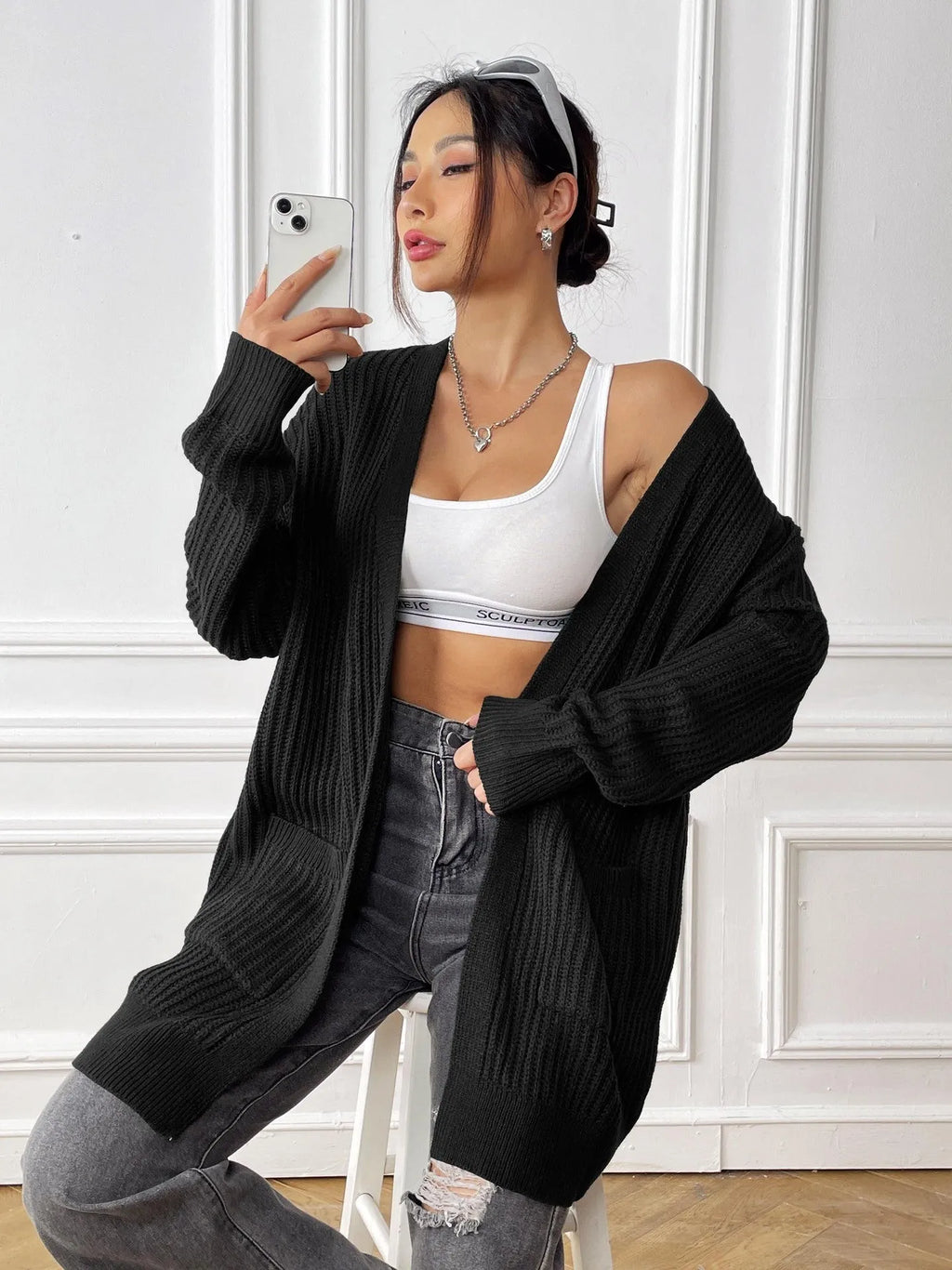 Women's dark green acrylic cardigan sweater with double pockets and long sleeves