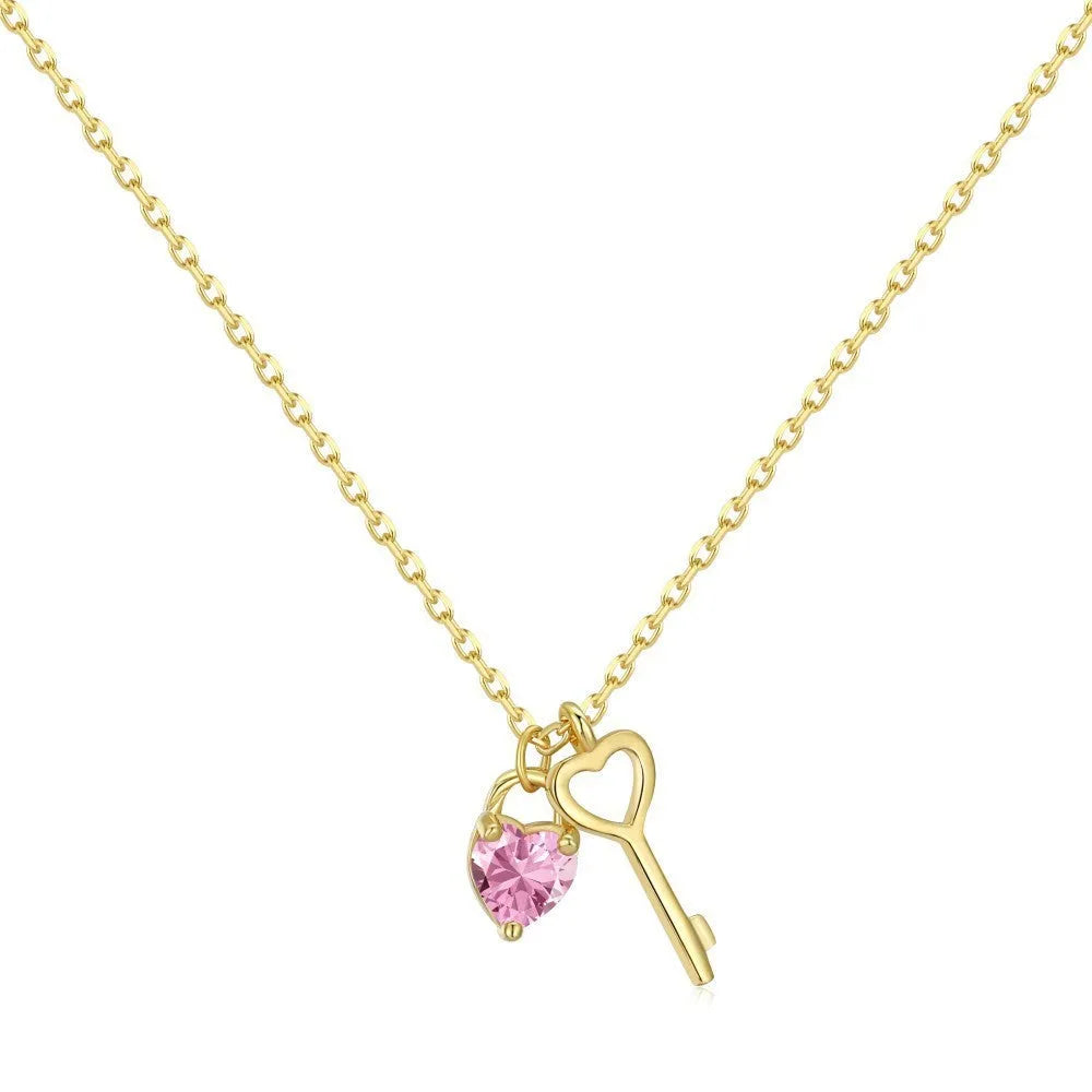925 sterling silver heart-shaped key pendant necklace in gold finish on display