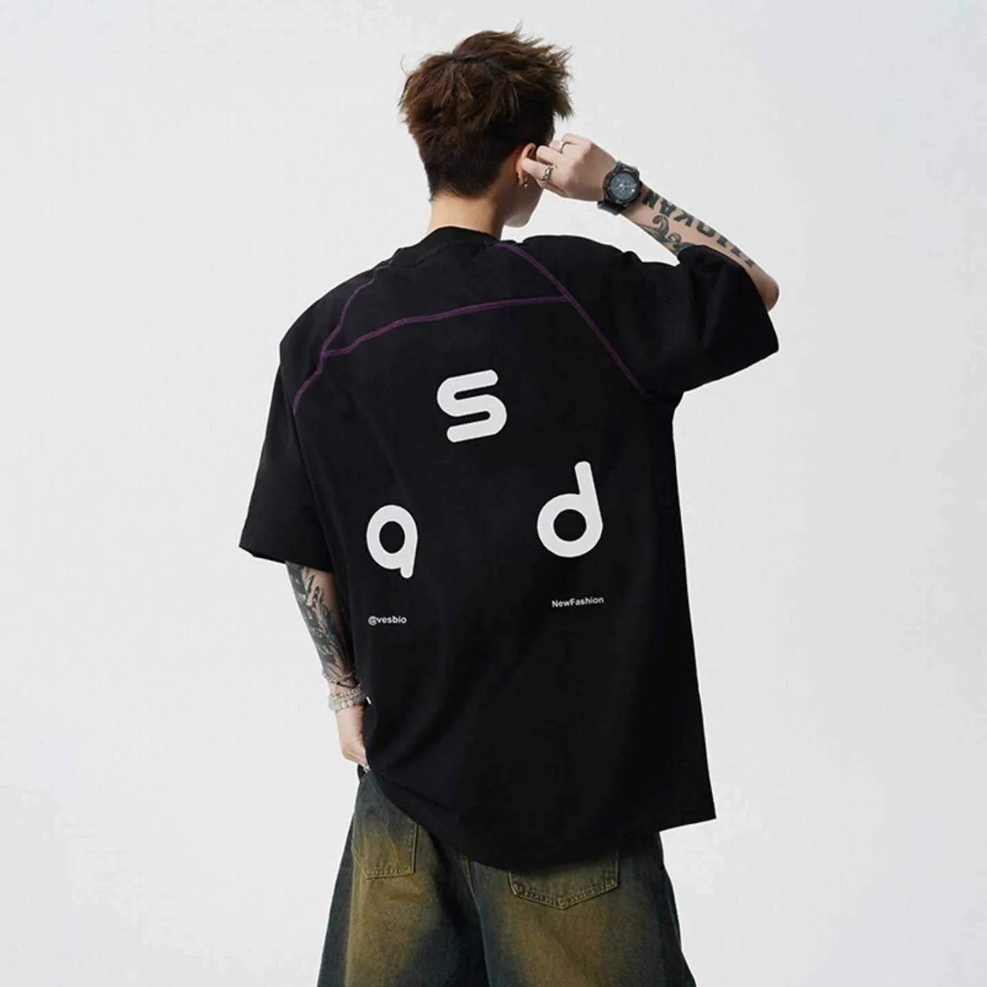 Man's loose fit black cotton T-shirt with large white letter print on the front.