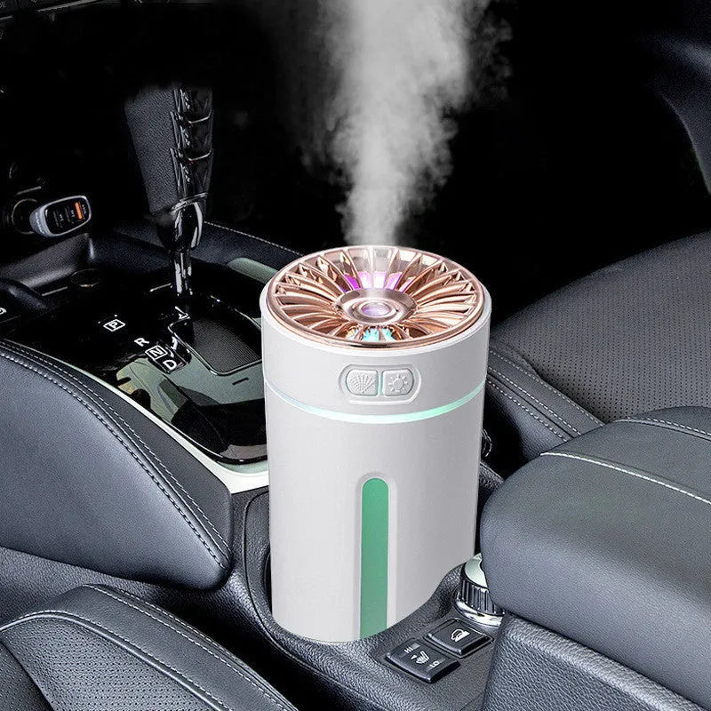 Compact black wireless humidifier with colourful LED lights sitting in car cup holder