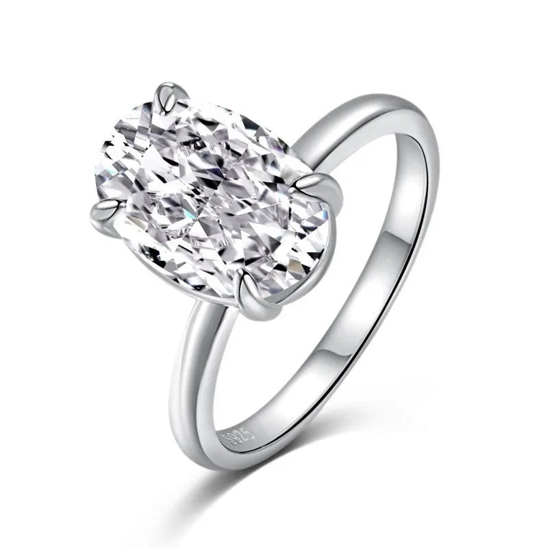 Oval women's ring with a four-claw setting on a silver band, showing gold and silver finish options.