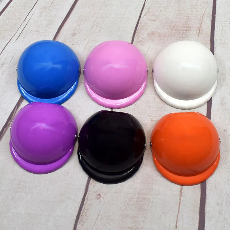 Small dog wearing a solid colour plastic motorcycle cap helmet on its head