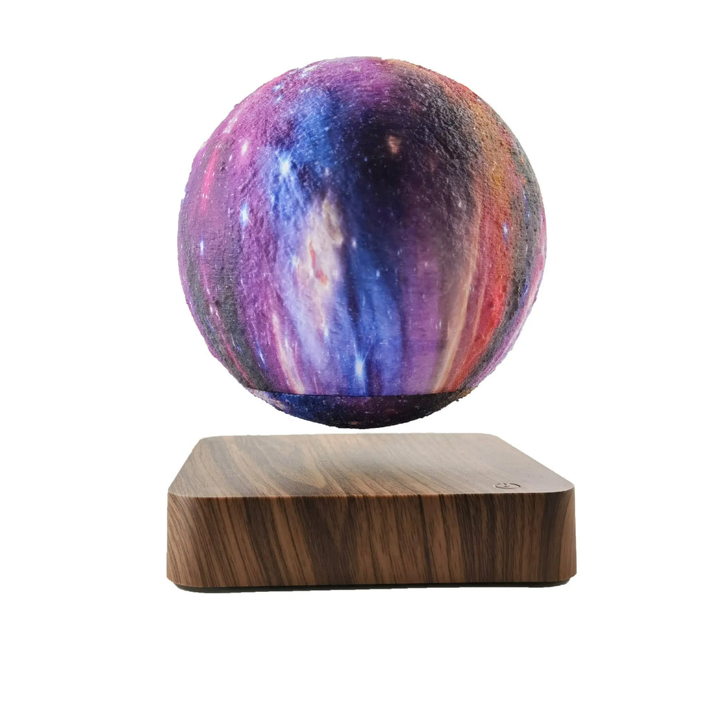 Magnetic levitation galaxy decorative light with rotating moon lamp above walnut-coloured circular base