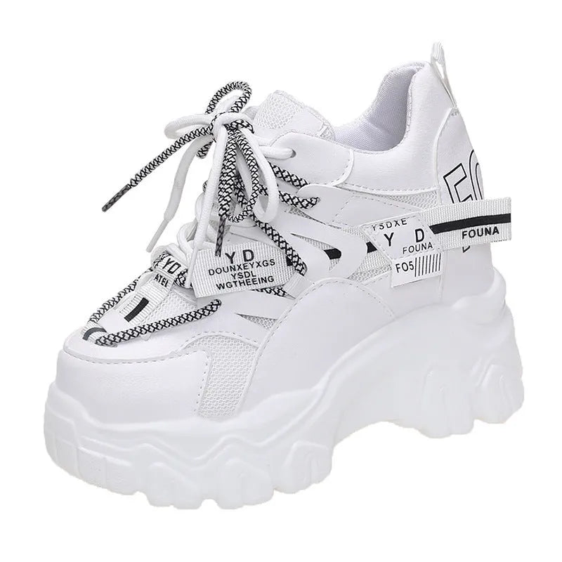 Women's white breathable mesh platform sports shoe with a cross strap on a rubber sole